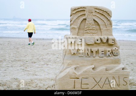 Sand sculpture on the Gulf coast beach in Port Aransas, Texas says 'We Love Winter Texans' Stock Photo