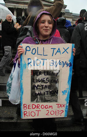 London, UK. 13th April 2013. Anti-Thatcher Protesters demonstration in Trafalgar Square.   Students, socialists and anarchists marked former prime minister's death by a demonstration in Trafalgar Square with Hundreds of police on standby to avoid any breach of peace. There are no official organisers of Saturday's protest, two decades ago, the anarchist collective Class War said there should be a gathering at Trafalgar square at 6pm on the first Saturday after Thatcher's death. Pictured: A young woman hold a protest placard. Credit David Mbiyu/Alamy Live News Stock Photo