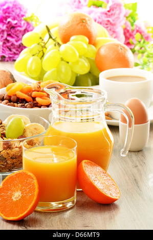 Breakfast including coffee, bread, honey, orange juice, muesli and fruits Stock Photo