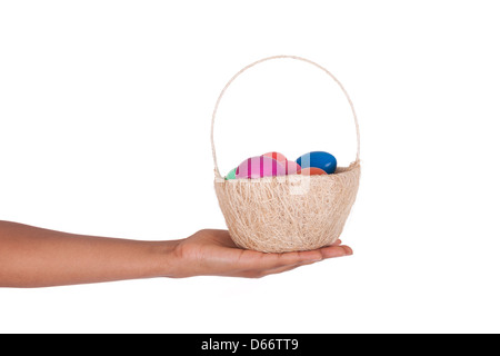 Hand holding colorful Easter eggs in the basket Stock Photo