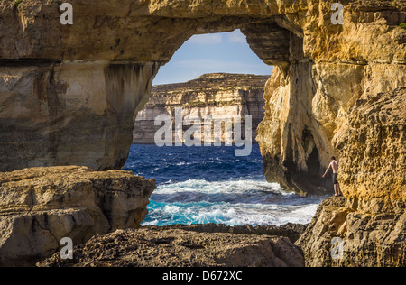 A boy scared of jumping at the Azure Window in Gozo Stock Photo