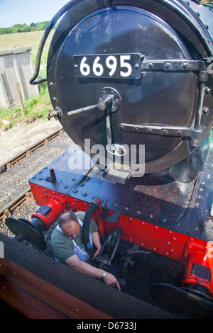 Ex GWR 0-6-2T No.6695 uncouples from its train at Norden station on the preserved Swanage Railway Dorset England UK Stock Photo