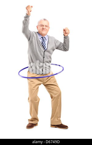 Full length portrait of a mature gentleman dancing with a hula hoop isolated on white background Stock Photo