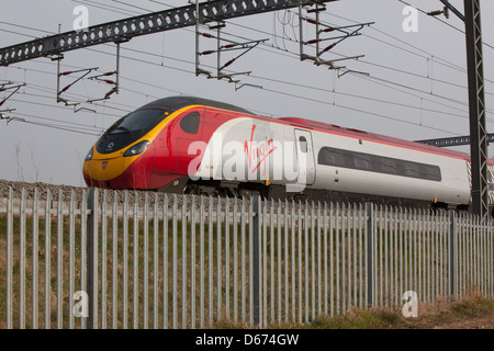 A Virgin train on the West Coast Mainline in the Midlands. Stock Photo