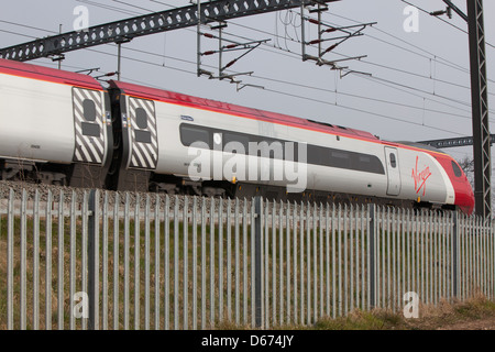 A Virgin train on the West Coast Mainline in the Midlands. Stock Photo