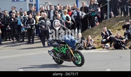 Nürburgring, Germany, 14 April 2013. Motorcycle stunt performer Chris Rid shows a trick at Nürburgring near Nuerburg, Germany, 14 April 2013. Several thousand motorcyclists attended a church service titled 'Anlassen' (Starting of the engine) and then rode along the Northern Loop in a procession. Photo: THOMAS FREY/Alamy Live News Stock Photo