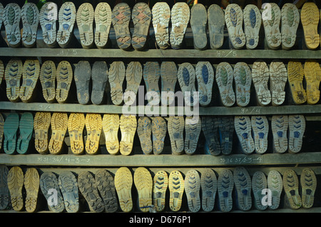Wellington boots on a rack in a jungle lodge in the Amazon rainforest Stock Photo