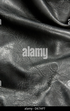 Closeup of crumpled shiny black leather texture. Stock Photo