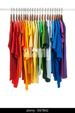 Colors of rainbow. Variety of casual shirts on wooden hangers, isolated on white. Stock Photo