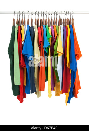 Variety of multicolored casual shirts on wooden hangers, isolated on white. Stock Photo
