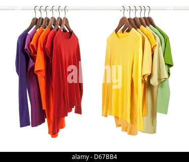 Choice of clothes of different colors on wooden hangers, isolated on white. Stock Photo