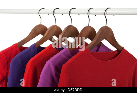 Choice of red and purple casual shirts on wooden hangers, isolated on white. Stock Photo