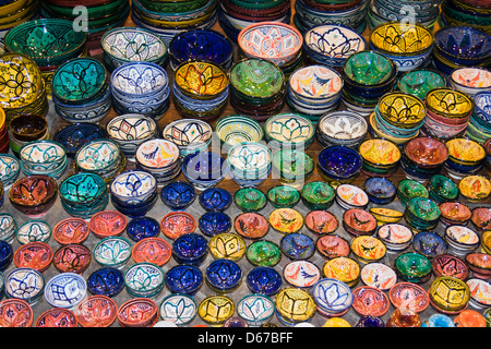 Brightly coloured ceramic dishes on sale at the market in Jamaa el Fna, Marrakesh or Marrakech, Morocco. Stock Photo