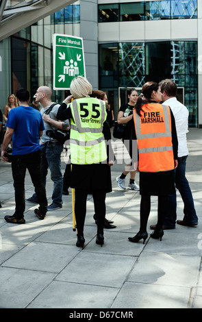 Staff assemble at fire safety point outside, 55 Baker Street, Marylebone, London, UK, Europe Stock Photo