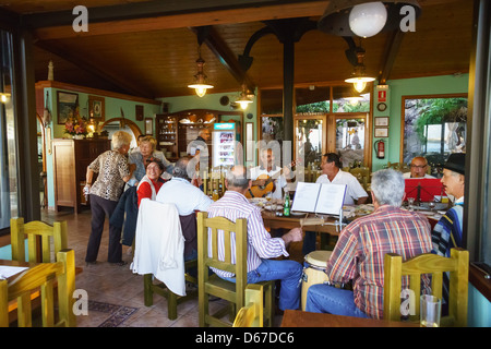 Local musicians and singers rehearse in the Kiosk Teneguia restaurant, Tazacorte, La Palma island. Stock Photo