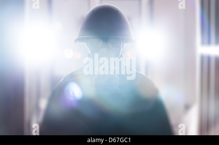 A man in military helmet and gas mask Stock Photo