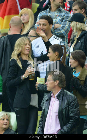 Sarah Brandner (front L-R), girlfriend of Germany's Bastian Schweinsteiger, Silvia Meichel, girlfriend of Mario Gomez, and Kathrin Gilch, girlfriend of Manuel Neuer, Sami Khedira's brother Denny Khedira (C) and girlfirend Lena Gercke (top R) during UEFA EURO 2012 quarter- final soccer match Germany vs Greece at Arena Gdansk in Gdansk, Poland, 22 June 2012. Photo: Marcus Brandt dpa  Stock Photo