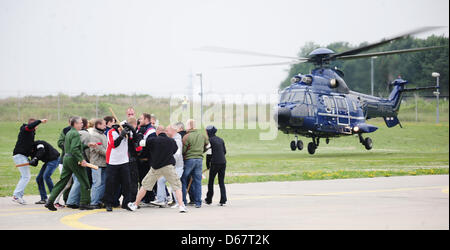 A Eurocopter AS 332 Super Puma helicopter takes part in an exercise at the site of the flying squadron of the German Fedral Police in Blumber, Germany, 27 June 2012. Policemen play the parts of angry hooligans. Photo: Hannibal Hanschke Stock Photo