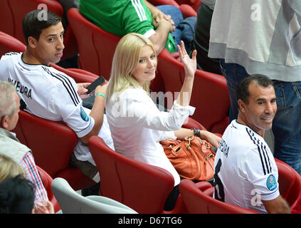 Germany's Lena Gercke (C), the girlfriend of Germany's Sami Khedira, and Denny (L), brother of Sami Khedira , and Germany's Sami Khedira's father Lazhar  seen on the stand prior to the UEFA EURO 2012 semi-final soccer match Germany vs Italy at the National Stadium in Warsaw, Poland, 28 June 2012. Photo: Marcus Brandt dpa (Please refer to chapters 7 and 8 of http://dpaq.de/Ziovh for Stock Photo