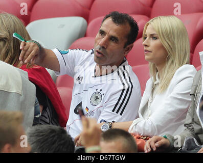 Germany's Lena Gercke (R), the girlfriend of Germany's Sami Khedira, and Germany's Sami Khedira's father Lazhar seen on the stand prior to the UEFA EURO 2012 semi-final soccer match Germany vs Italy at the National Stadium in Warsaw, Poland, 28 June 2012. Photo: Jens Wolf dpa (Please refer to chapters 7 and 8 of http://dpaq.de/Ziovh for UEFA Euro 2012 Terms & Conditions)  +++(c) dp Stock Photo