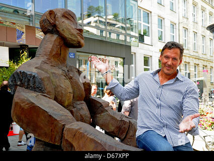 The actor Ralf Moeller sits on a sculptur during the summer festival of the actors agencies Reuter and Scenario in Munich, Germany, 30 June 2012. The actors agencies Reuter and Scenario invited their actors on the occasion of the film festival Munich. Photo: Ursula Dueren Stock Photo