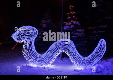 snake made from blue neon light. New Year decor the city park Stock Photo