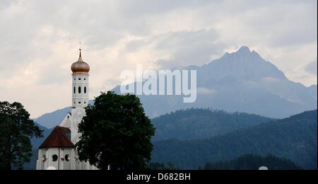 St Coloman Church is seen in front of the cloudy sky near Schwangau, Germany, 02 July 2012. Meteorologists predict cloudy weather for the coming days. Photo: Nicolas Armer Stock Photo