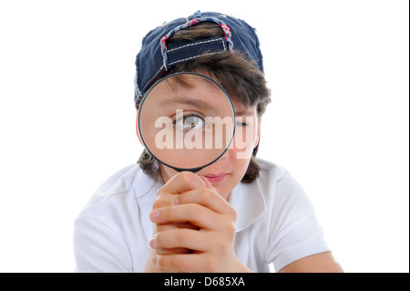 boy looking through a magnifying glass Stock Photo