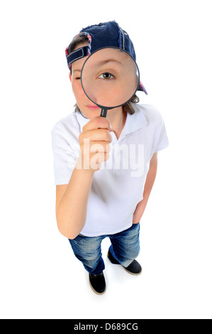 boy looking through a magnifying glass Stock Photo