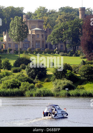 A motor boat sails past Babelsberg Palace in Potsdam, Germany, 10 July 2012. The palace, designed by Karl Friedrich Schinkel in 1833,  was the summer residence of the later Emperor William I. The exterier and surrounding terraces will be restored for a total cost 9.7 million euros. Photo: Bernd Settnik Stock Photo