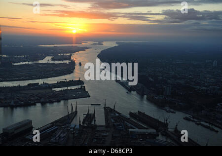 (FILE) An archive photo dated 19 September 2011 shows parts of the Port of Hamburg and the Elbe River at sunset in Hamburg, Germany. The year long dispute over the dredging of the Elbe is going to court. The suit by the environmental organizations BUND, NABU and WWF should be complete on Firday 06 July 2012, according to their reports. The dredging will allow large container ships  Stock Photo