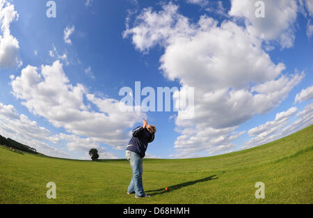 (file) - A dpa file picture dated 04 May 2010 shows a man playing golf in Essen, Germany. For each resident of North Rhine-Westphalia, there are four square meters of golf court. Photo: Julian Stratenschulte Stock Photo