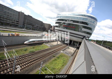 An ICE train leaves the station at the office building 'The Squaire' at the airport in Frankfurt am Main, Germany, 22 July 2012. Hotels, firms and shops are hosted in the building. Photo: Fredrik von Erichsen Stock Photo