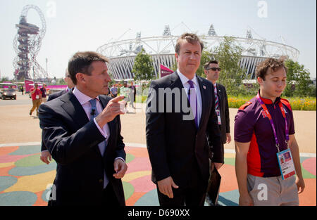 British Prime Minister David Cameron (C) and London Organising Committee of the Olympic and Paralympic Games (LOCOG) Chairman Lord Sebastian Coe (L) visit the Olympic Park at the London 2012 Olympic Games, London, Britain, 26. July 2012. The London 2012 Olympic Games will start on 27 July 2012. Photo: Michael Kappeler dpa  +++(c) dpa - Bildfunk+++ Stock Photo