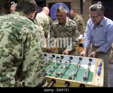 HANDOUT - A handout picture by the Bundeswehr shows German Minister of Defence Thomas de Maiziere (R) playing table soccer with German soldiers at Camp Warehouse in Kabul, Afghanistan, 26 July 2012. Maiziere had previously paid the first visit of a German Minister of Defence to German soldiers in the Taliban stronghold Kandahar. Photo: JULIAN REICHELT Stock Photo