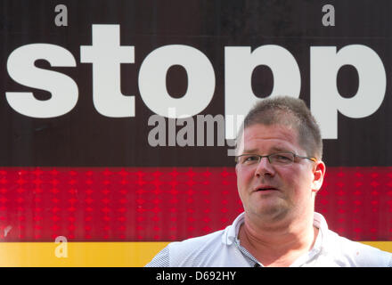 Chairman of the right-extremist National Democratic Party (NPD) Holger Apfel stands in front of an NPD truck in Frankfurt Main, Germany, 27 July 2012. Several hundred protesters prevented that the NPD could enter Roemerberg square with a loudspeaker van during their so-called 'Tour of Germany'. Photo: BORIS ROESSLER Stock Photo