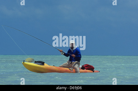 Fly fisherman looking for bonefish from his kayak in Ascension Bay Yucatan Quintana Roo Mexico Stock Photo