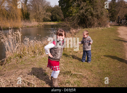 Young Brother and Sister Children Playing Together In The Countryside UK Stock Photo