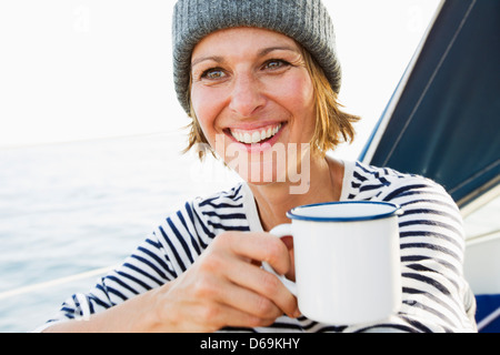 Smiling woman having cup of coffee Stock Photo