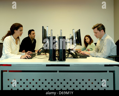 Business people using computers at desk Stock Photo