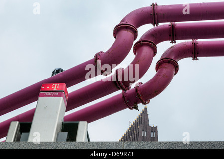 T-mobile hotspot under pink pipes that drain surface water from construction sites in Berlin Stock Photo