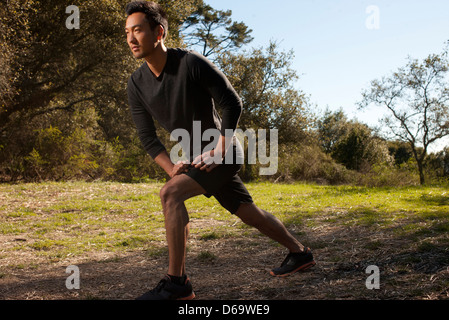 Runner stretching in park Stock Photo