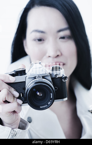 Woman taking pictures with camera Stock Photo