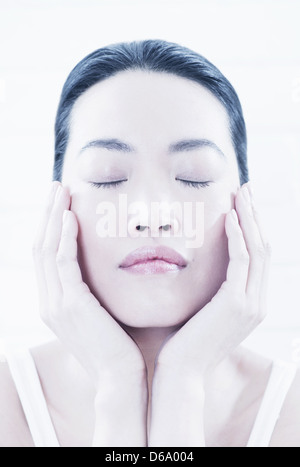 Close up of woman cupping her chin Stock Photo