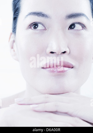 Close up of woman resting chin in hands Stock Photo