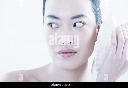 Woman applying ice pack to face Stock Photo