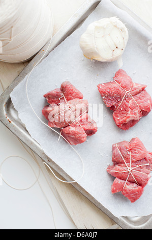 Tray of meat with garlic and salt Stock Photo