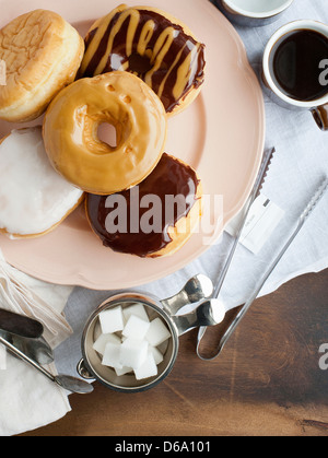 Plate of donuts with coffee and sugar Stock Photo