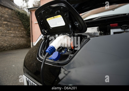Charging the batteries of a Nissan LEAF all electric zero emissions car. Stock Photo