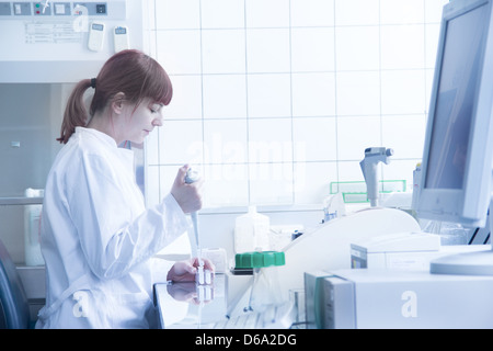 Scientist filling test tubes with pipette in laboratory. Close up Stock ...